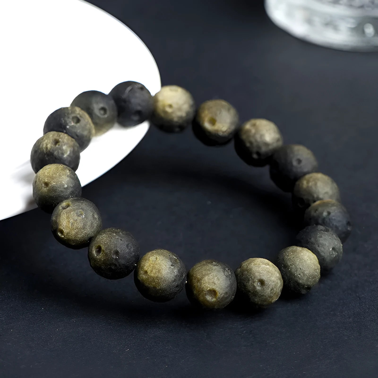 Unisex natural obsidian crater ball bracelet in silver stone meteorite colour with textured beads.