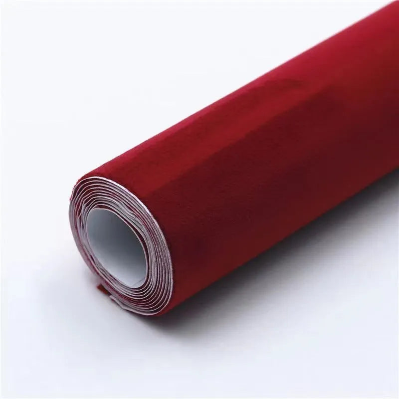Roll of self-adhesive leather suede fabric in BMW brown colour next to a car dashboard.