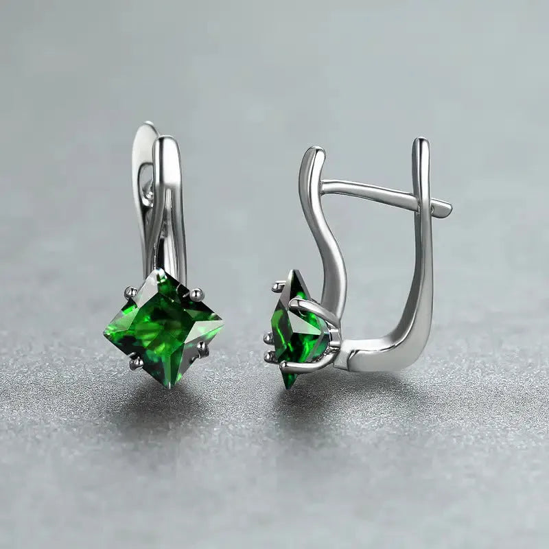 Women's copper earrings with diamond design and inlaid blue zircon stone.