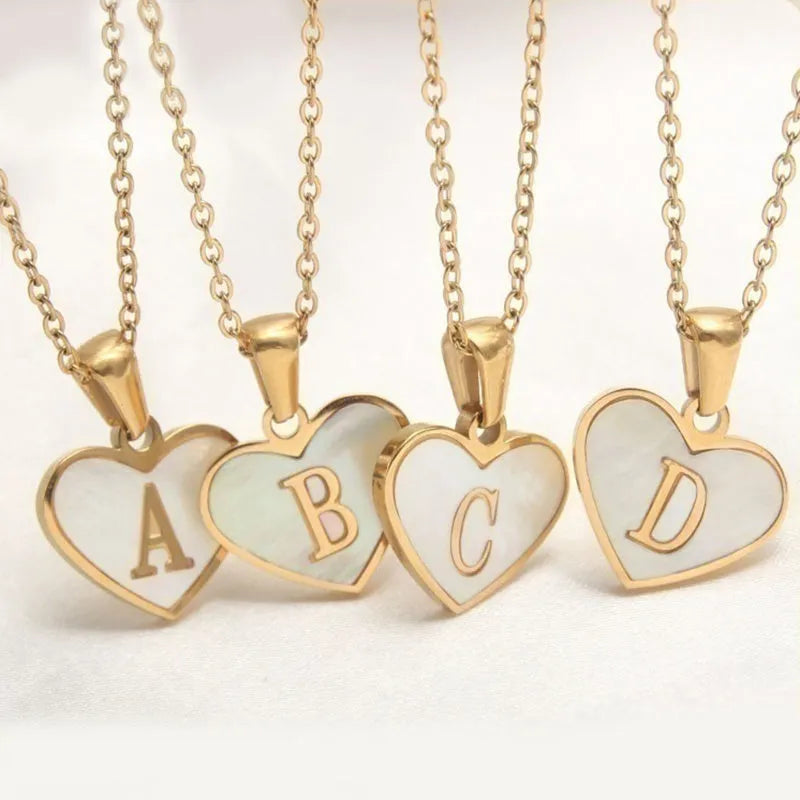 Gold plated heart-shaped white shell necklace with personalised text on a stainless steel chain.