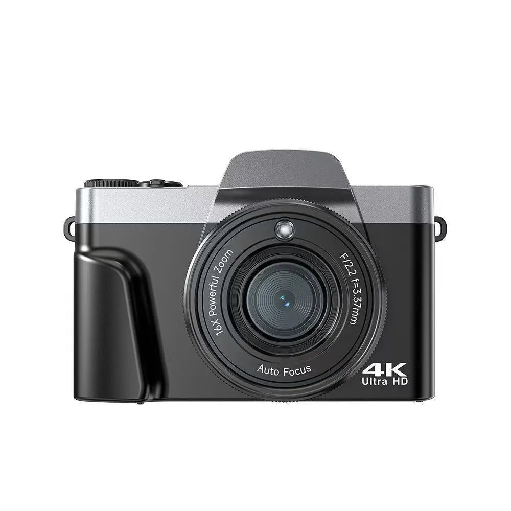 Black flip mirrorless digital camera resting on a cloth surface, showing its compact body and flip screen