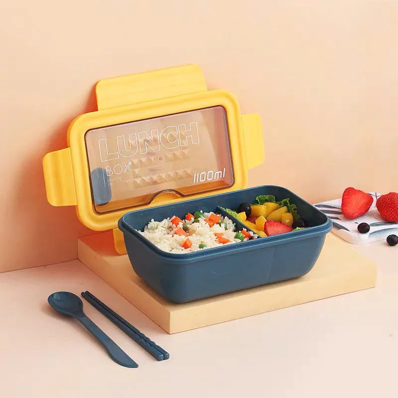 Green four-layer partitioned bento box with Nordic style design on a table.