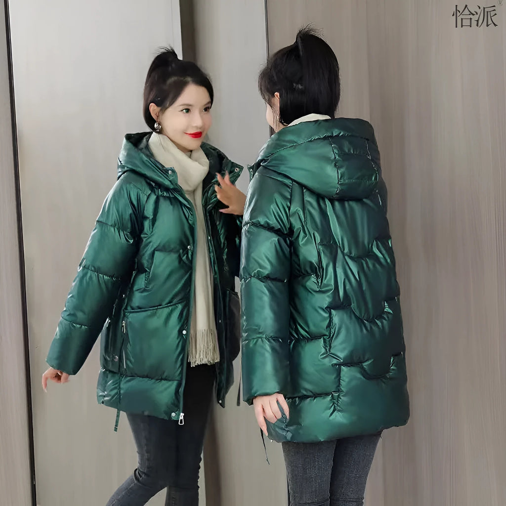 A woman wearing a green ultra-thin hooded winter jacket with long sleeves, showing the front design.