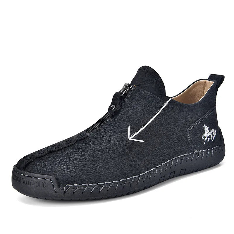 Men's black leather casual boot with front zip, round toe, and rubber sole on a white background.