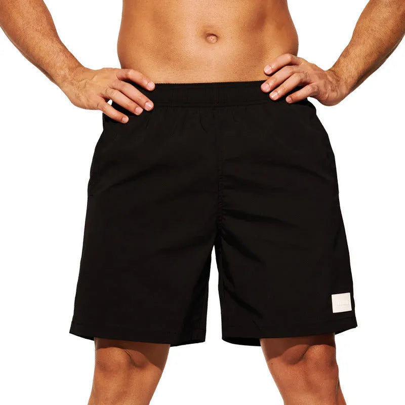 Men's nylon sports shorts in solid colours with straight leg opening and elastic waistband