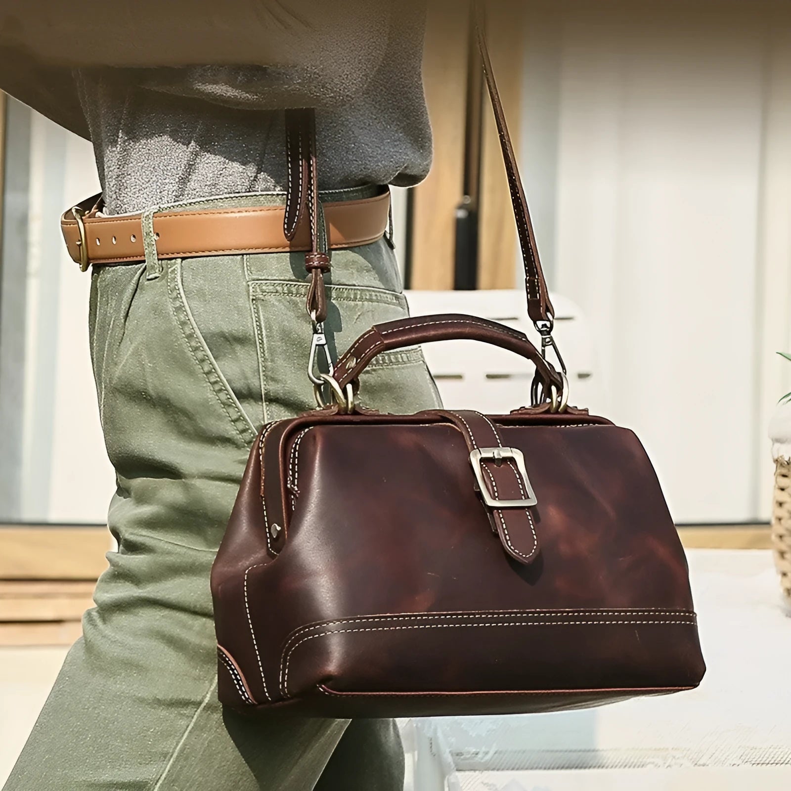 Reddish brown genuine leather women's shoulder messenger bag with sewing line details and crossbody strap
