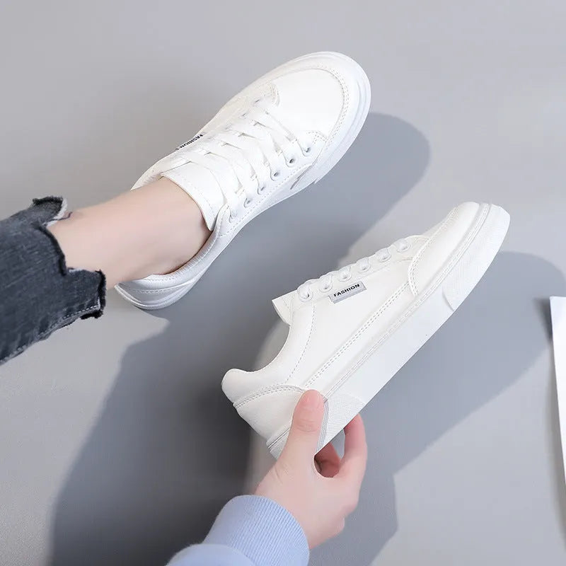 Korean style women's low-top sneakers in white or brown artificial PU with plastic sole.
