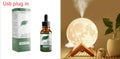 Wood finish Lunar humidifier night light with spherical design on a table.