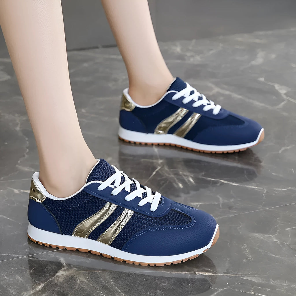Blue women's lightweight sports shoes with cross straps and lace-up front on a flat rubber sole.