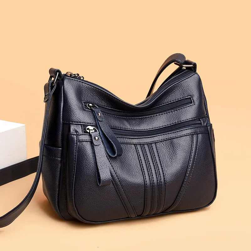 Genuine leather cross-body messenger bag in horizontal square shape with internal organisers
