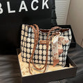 Black woolen horizontal square shoulder bag with weaving detail exterior and internal organisation compartments