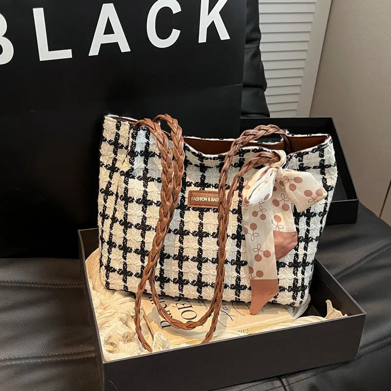 Black woolen horizontal square shoulder bag with weaving detail exterior and internal organisation compartments