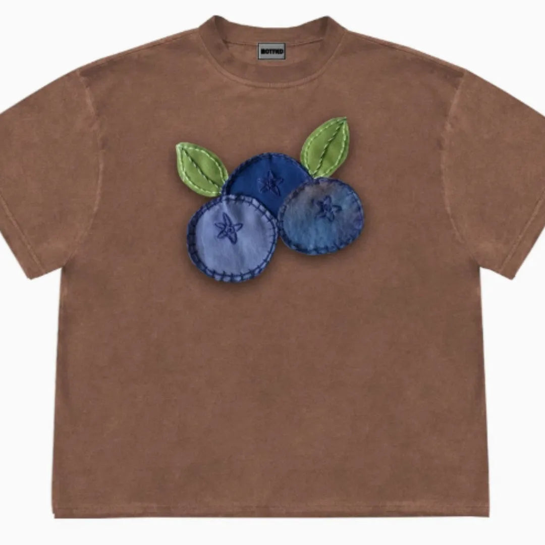 Loose fit blueberry fruit patchwork print short sleeve T-shirt on a hanger