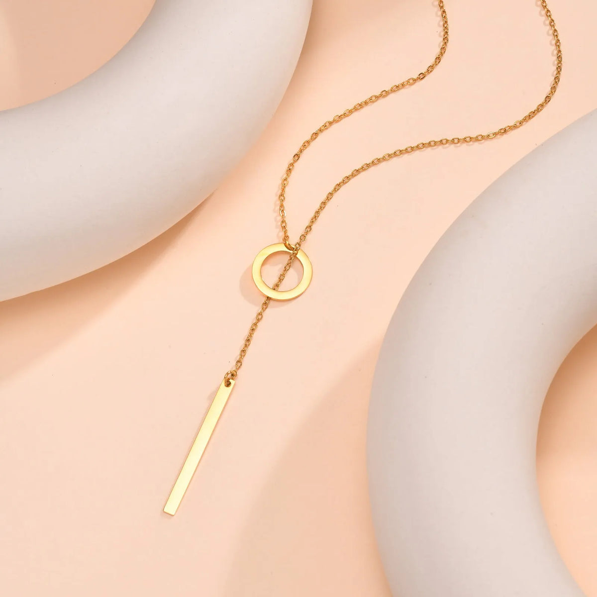 Gold stainless steel cross necklace with round ring pendant on an O-link chain for women