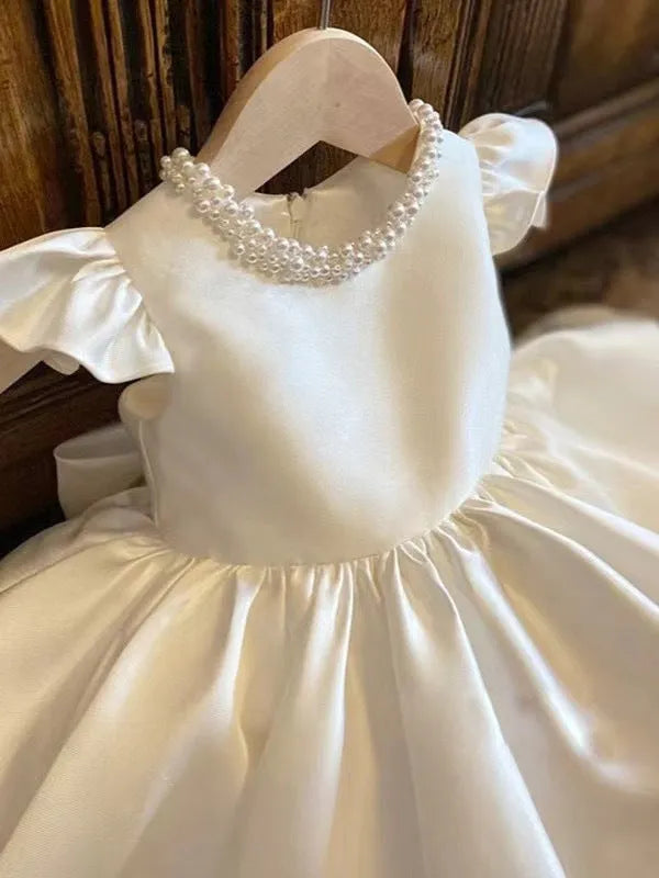 Girls' white satin princess dress with puff sleeves, full-length view, white fabric