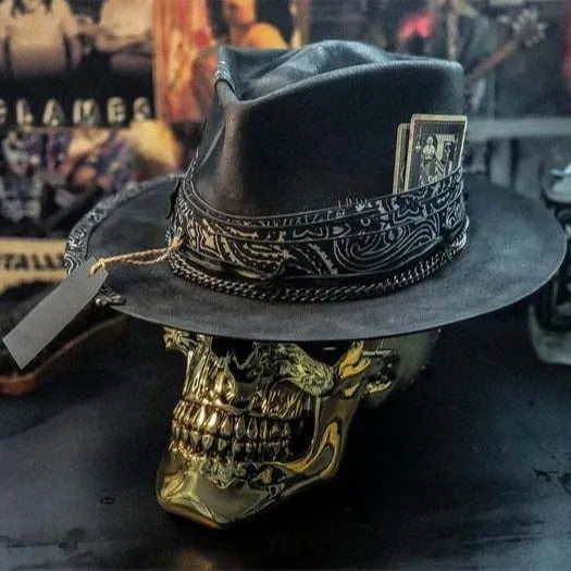 Handmade denim-blue wool felt skull hat with embroidered white skull on front and structured conical crown.