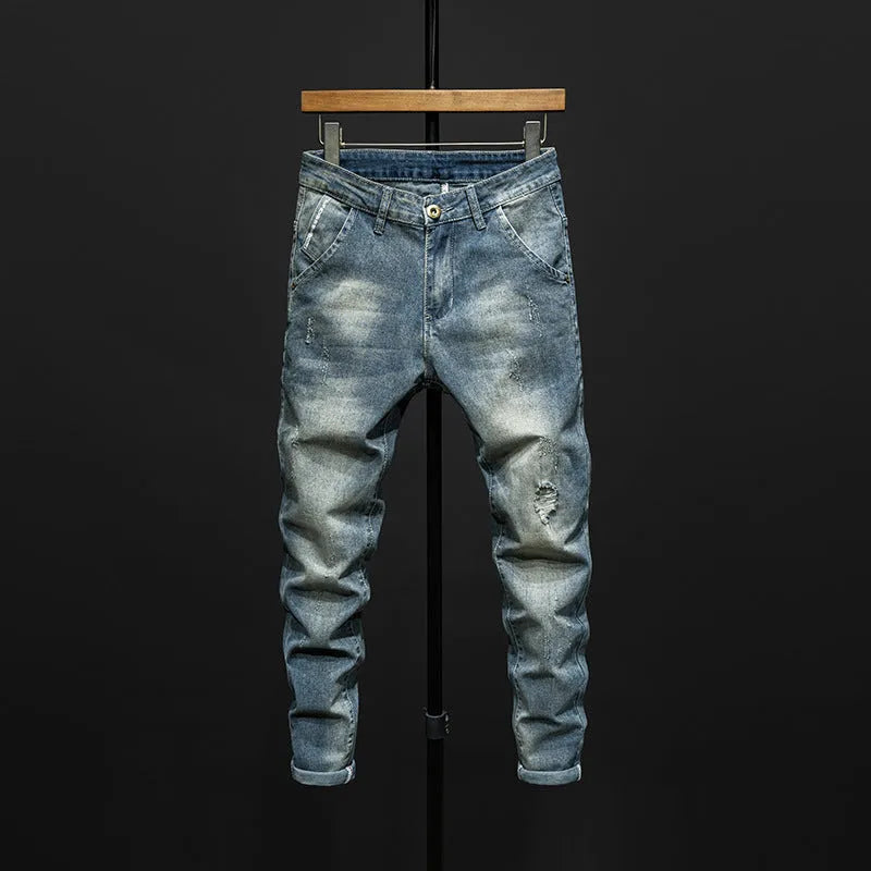 Men's slim-fit skinny jeans in dark blue cotton denim fabric on a hanger.