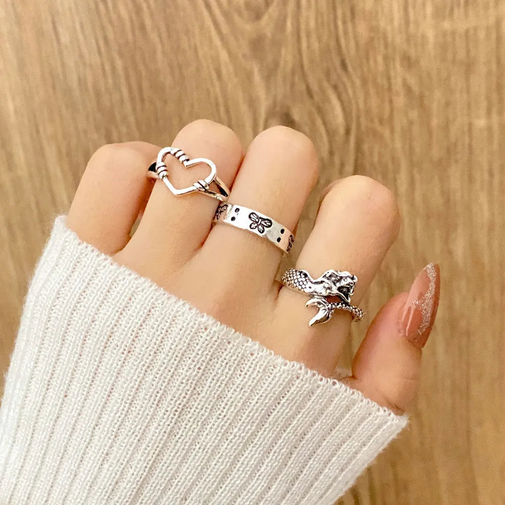 Alloy ring set with butterfly and snake retro geometric designs on display