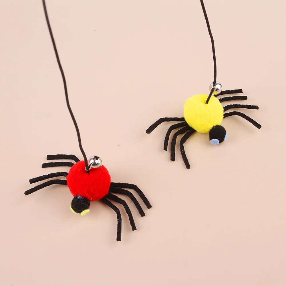 Cat toy with elastic rope hanging over a door, featuring a feather wand, jingle bell, and dangling spider attachment.