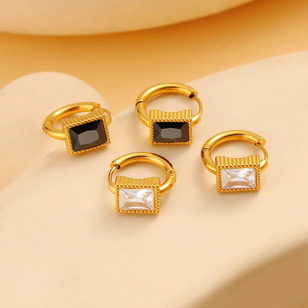 A pair of square stainless steel earrings with round zircon details, shown in a choice of black, green, or white colour.