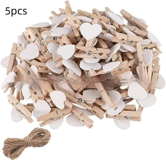 Set of five handmade solid wood heart-shaped clips in assorted colours on a wooden surface.