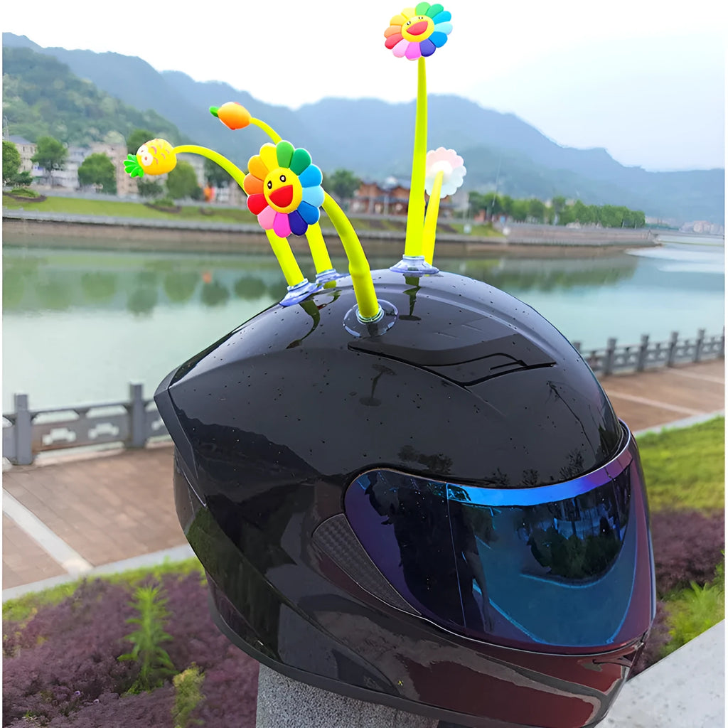 Yellow silicone sunflower helmet decoration with a black suction cup base attached to a helmet.