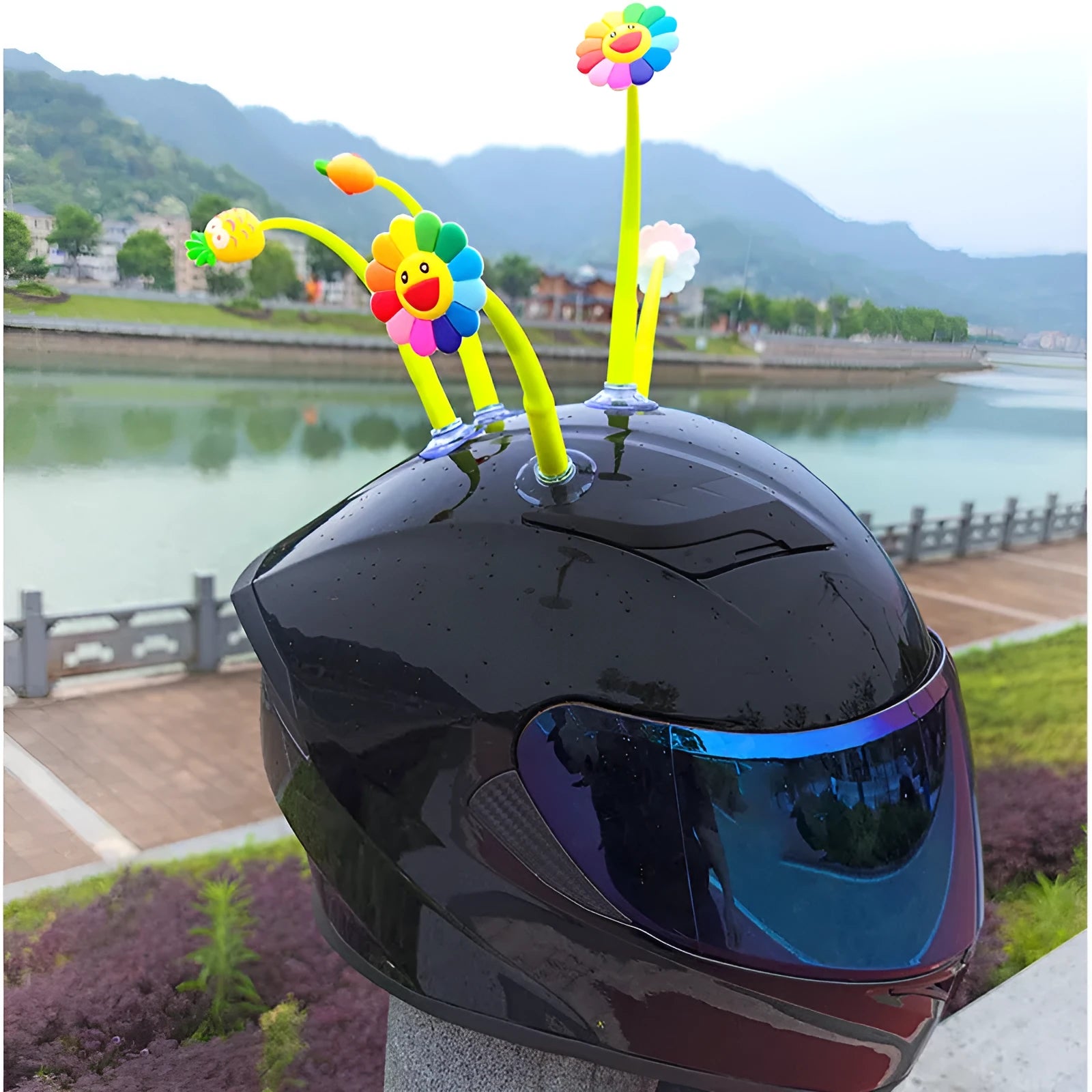 Yellow silicone sunflower helmet decoration with a black suction cup base attached to a helmet.