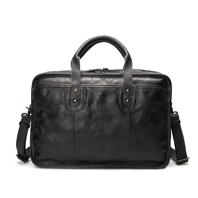 Brown vintage leather men's briefcase open showing internal laptop sleeve and multiple organisation pockets