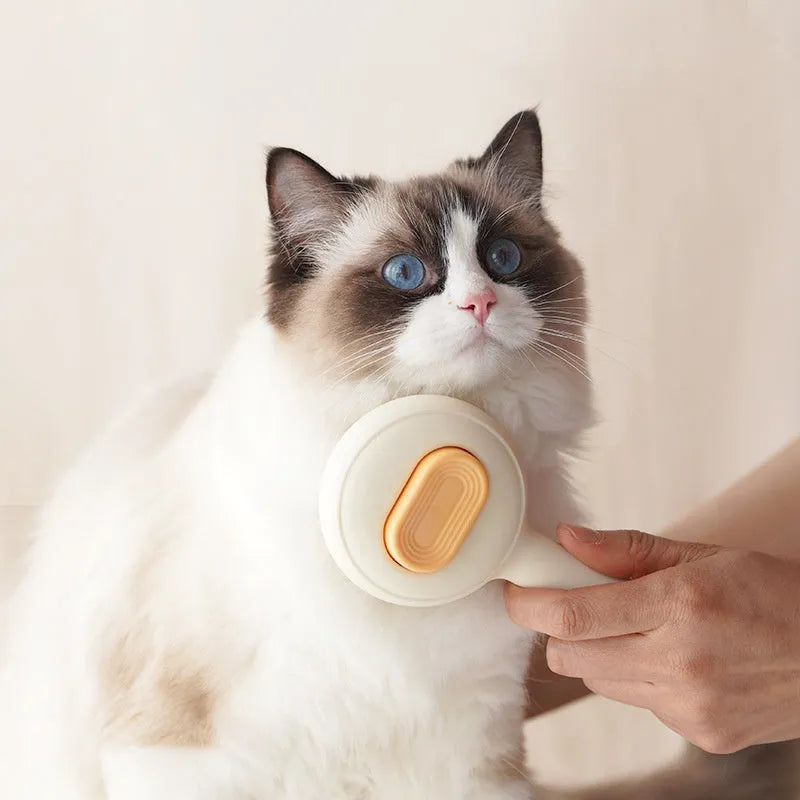 Green cat grooming brush with stainless steel pins and non-slip handle for pet hair removal