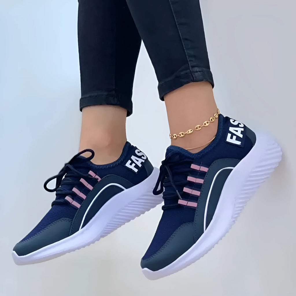 Women's lace up mesh sneakers in pink with cross strap design, round toe, rubber sole, medium heel