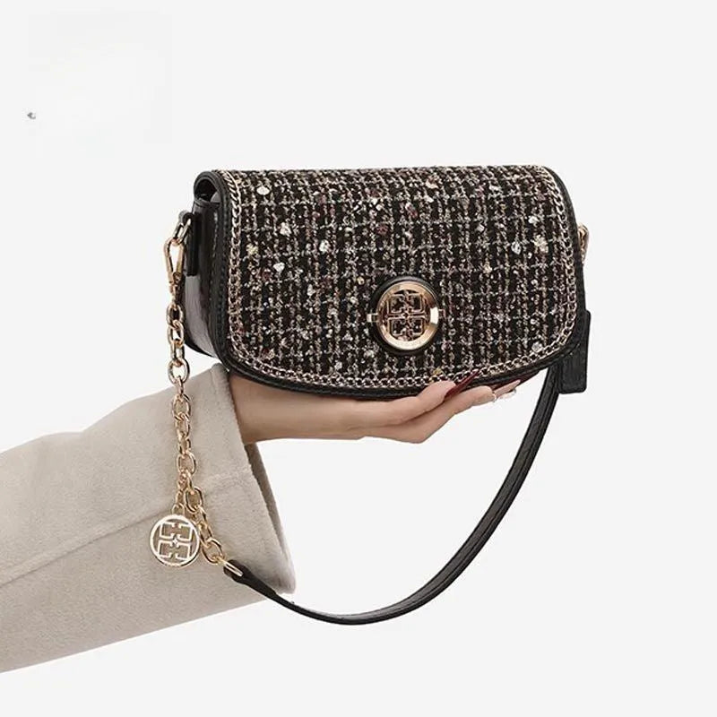 Black polyester crossbody underarm chain shoulder bag with chain strap on white background