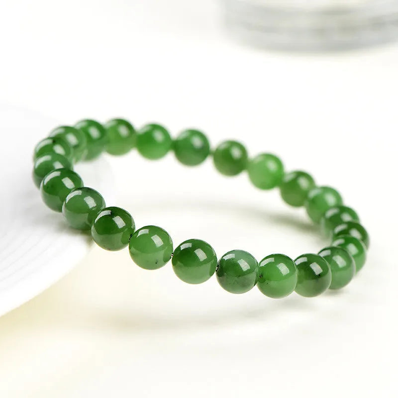 Natural Hetian jade jasper ball bracelet showing polished beads on a wrist.