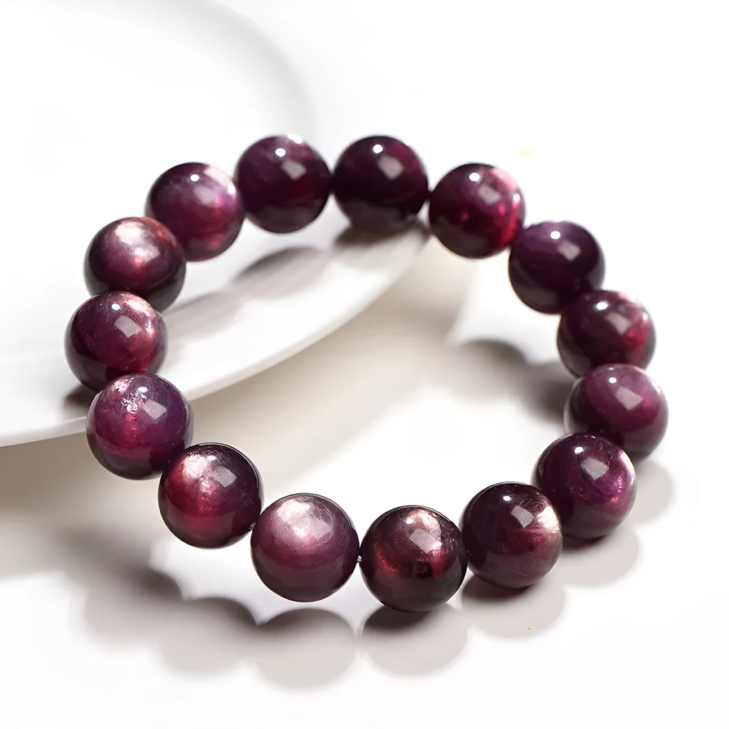 Natural purple lepidolite crystal bracelet with polished round beads on a white background.