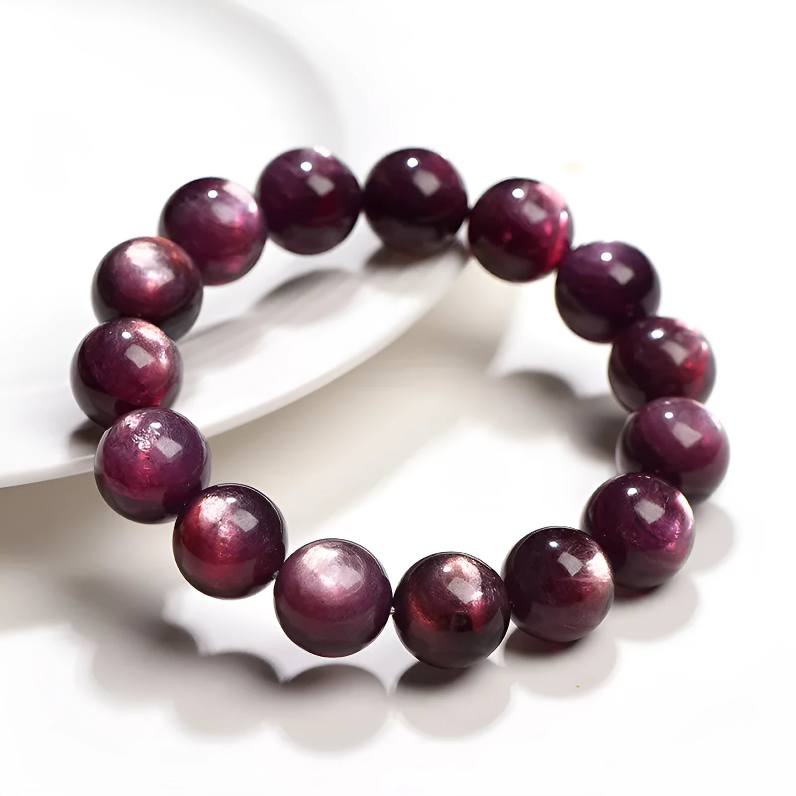 Natural purple lepidolite crystal bracelet with polished round beads on a white background.