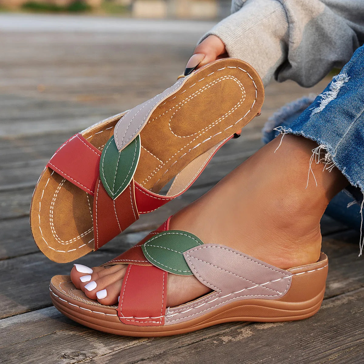 Women's black thick-soled slippers with a cross-strap and peep-toe design on a light background