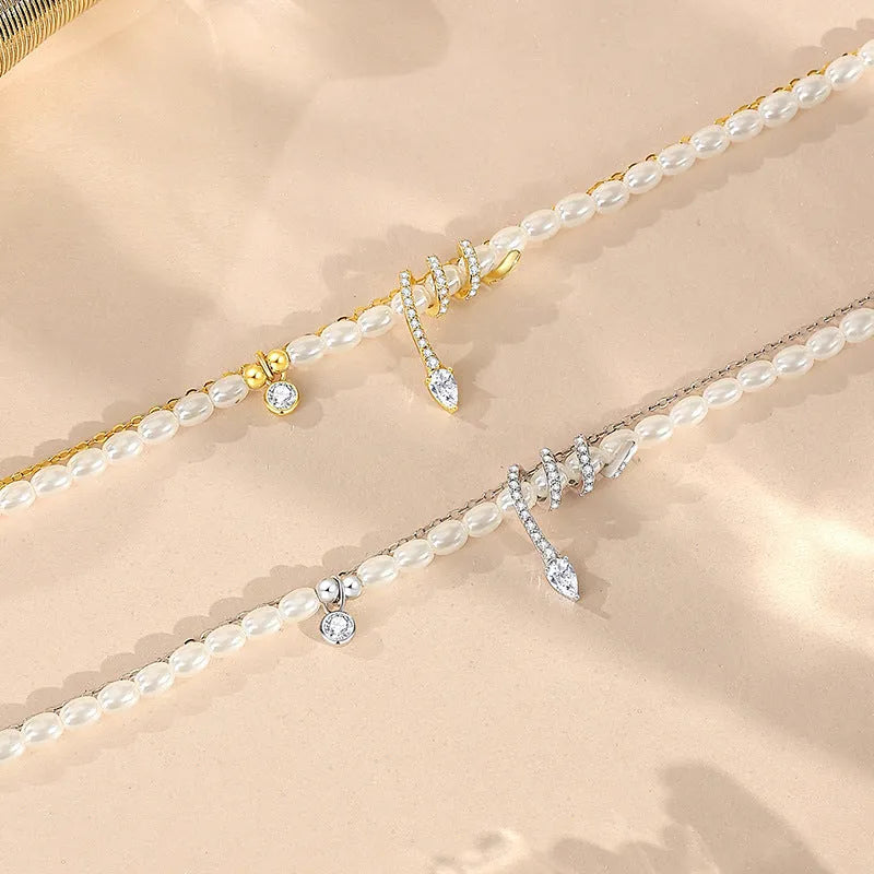 Close-up of a women's silver bracelet with a detailed pearl snake design, shown in both gold and white gold colour options.