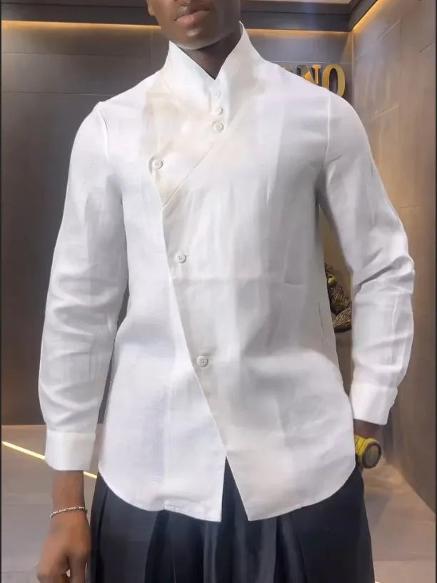 White asymmetrical shirt and black pleated trousers co-ordinate set laid flat