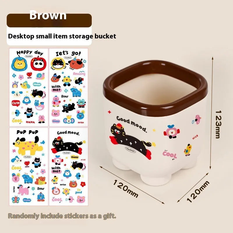 Cartoon-style plastic desktop organiser with grid compartments and red or brown stickers.
