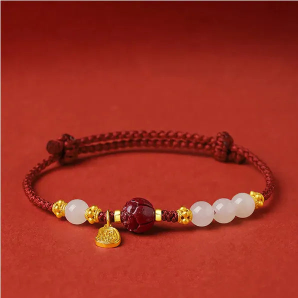 Handmade women's bracelet with cinnabar red rope, 925 silver, and Hetian jade on an adjustable chain.