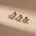 Stainless steel inner rod ear bone stud with geometric shape and electroplated finish on silver background