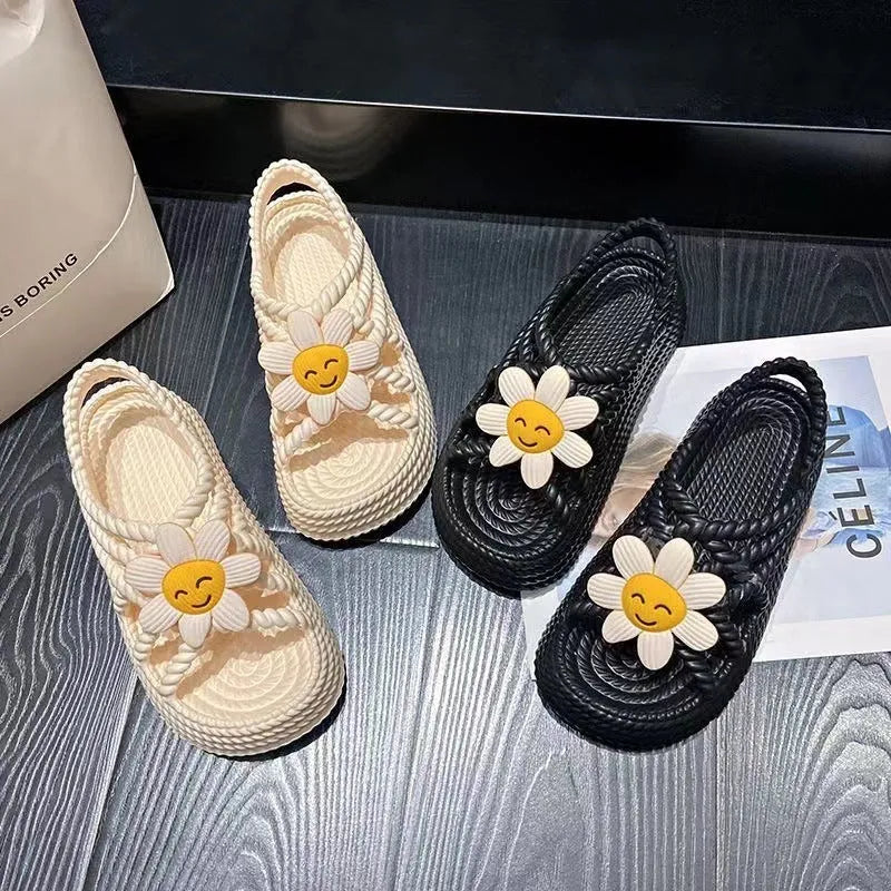 Women's PVC sandals with flower decorations in beige and black colours showing round-toe non-slip design