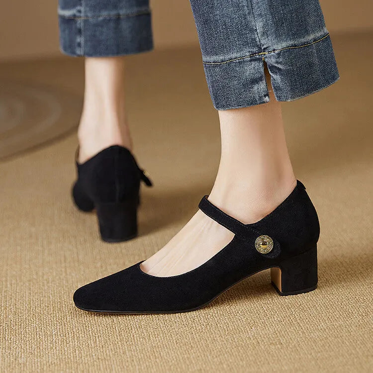 Women's black suede Mary Jane shoes with a square toe and chunky heel on a white background.