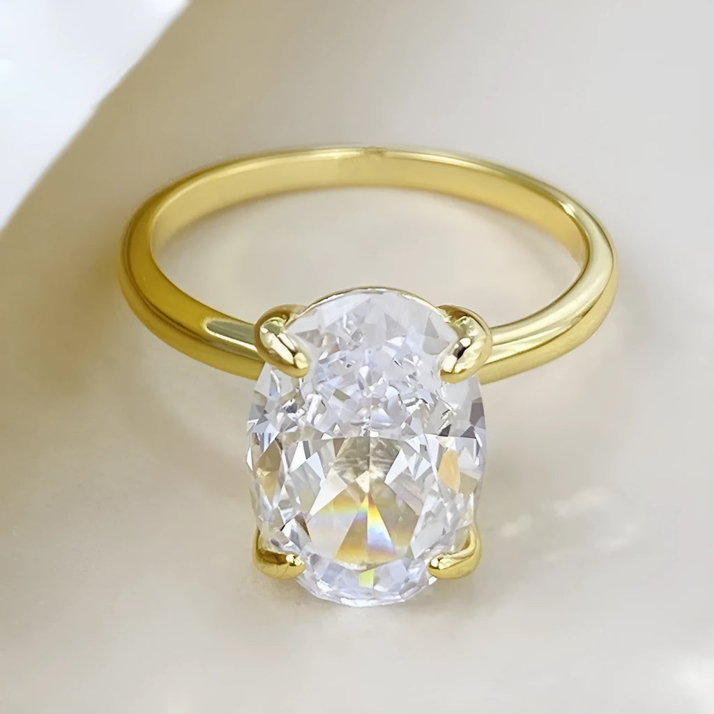 A women's oval sterling silver ring with a four-claw setting holding a single stone.