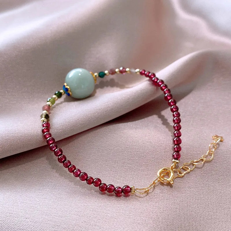 Aquamarine garnet bracelet with drop-shaped tourmaline centrepiece on wrist