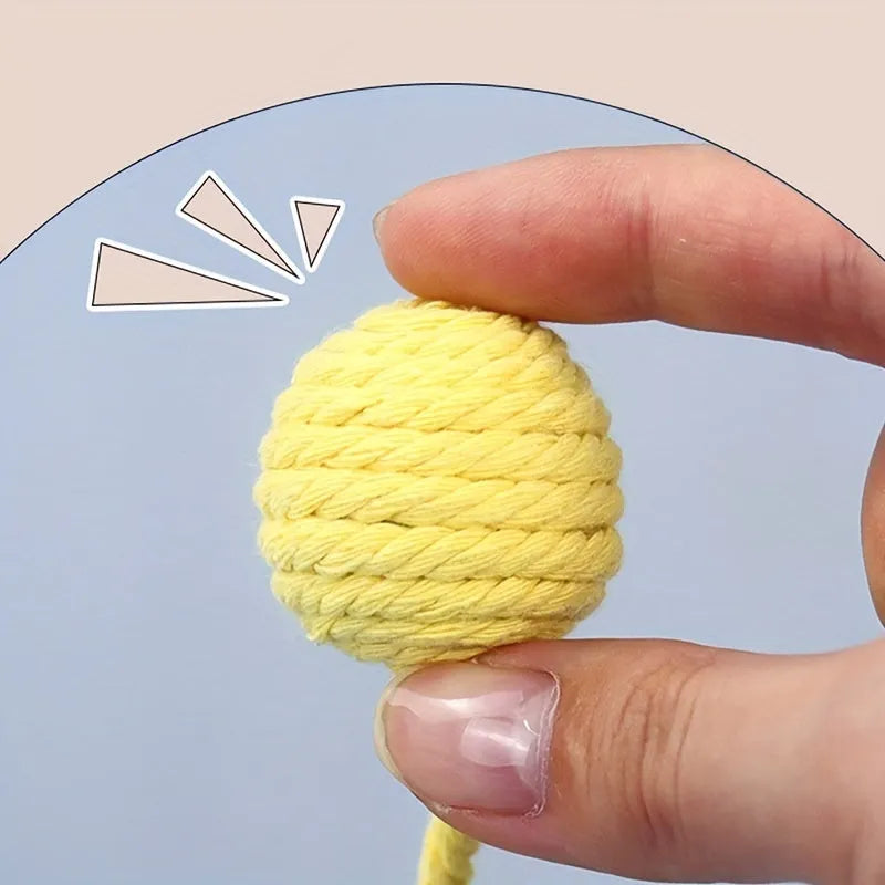 Cat toy ball with rope attachment and bell inside, shown in green, pink, purple, and yellow colour options