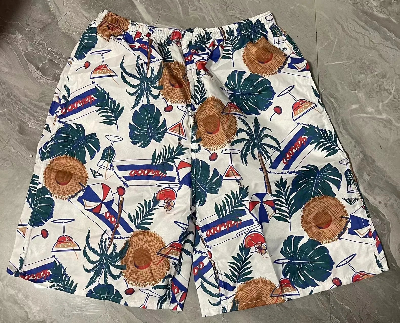 Men's floral printed swimming trunks in polyester with five-point design for beach and pool use