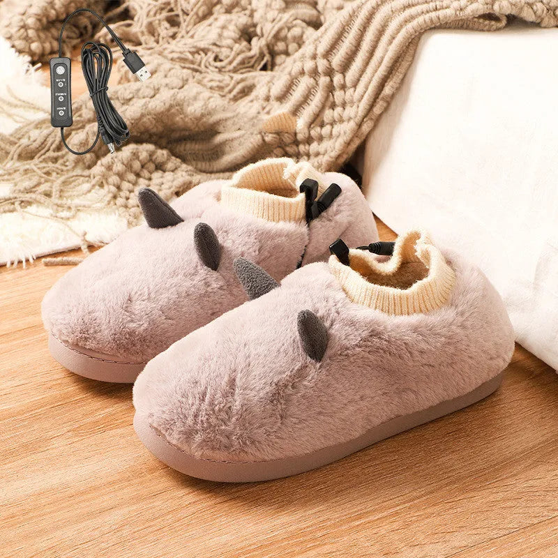 USB electric foot warmer slippers in grey with a connected USB cable on a wooden floor.