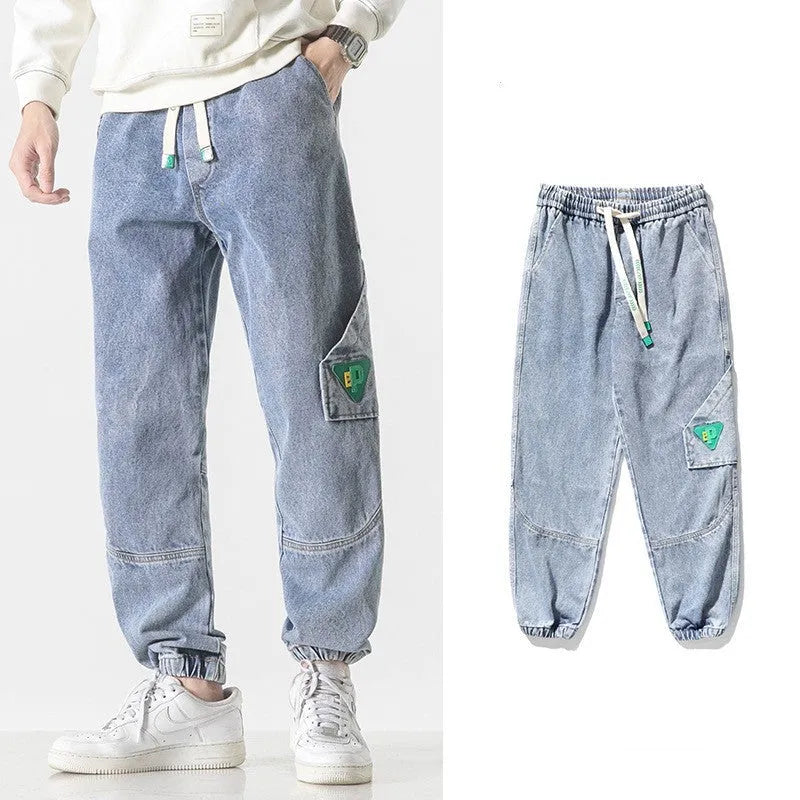 Men's loose-fit tapered cotton trousers showing tapered leg and mid-waist design in black colour