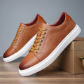 Men's low-top black leather-style shoes with decorative stitching and a rubber sole.