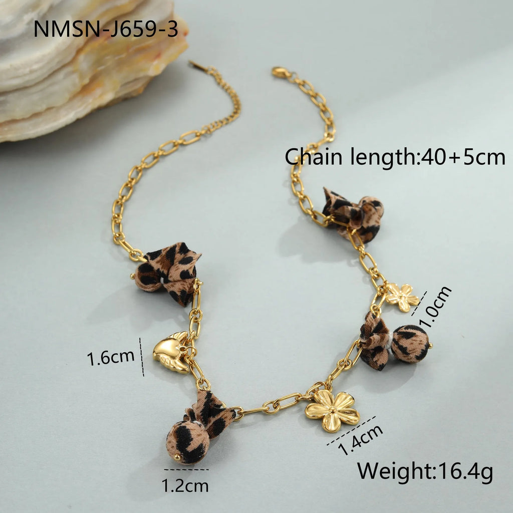 Stainless steel heart pendant necklace with geometric leopard and flower charms on adjustable chain